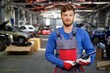 © Nejron Photo - Cheerful serviceman in a car workshop