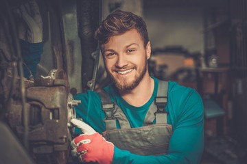 Sticker - Mechanic checking car brake system in a workshop