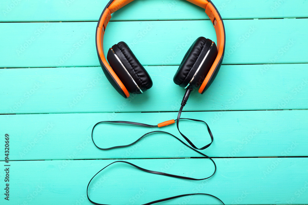 Headphones on wooden background