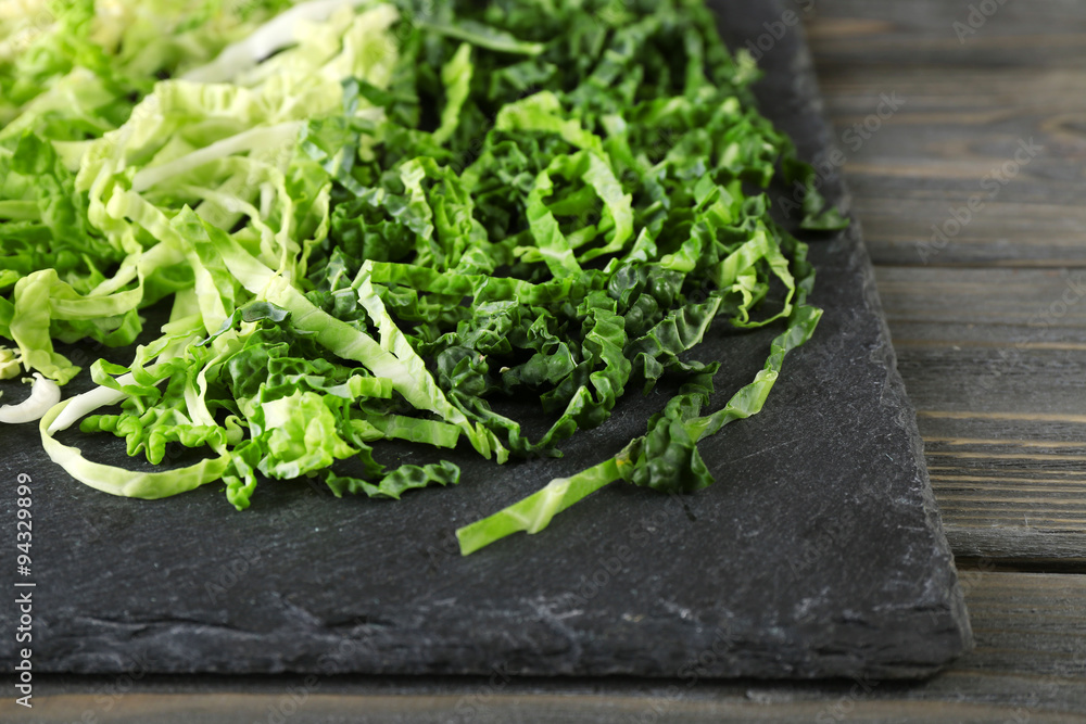 Cut savoy cabbage on wooden background