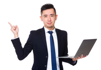 Wall Mural - Asian Businessman hold with notebook computer and finger point u