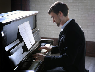 Poster - Handsome man in black suit plays piano in the class