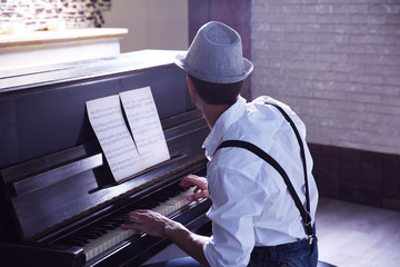 Poster - Handsome young man in hat making piano music