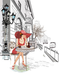 Wall Mural - Fashion girl sitting in the cafe in the old town