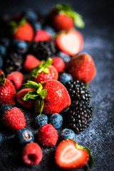 Wall Mural - Berry mix on rustic black background