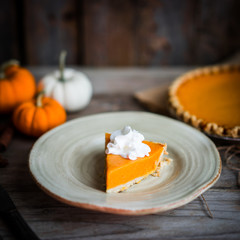 Pumpkin pie on rustic wooden background