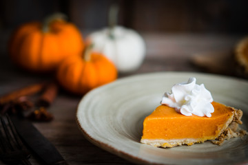 Wall Mural - Pumpkin pie on rustic wooden background