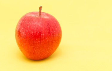 Canvas Print - ripe apple on a yellow background