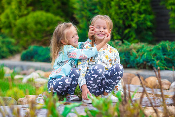 Wall Mural - Little adorable girls at warm sunny autumn day outdoors