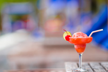 Tasty alcoholic cocktail background swimming pool