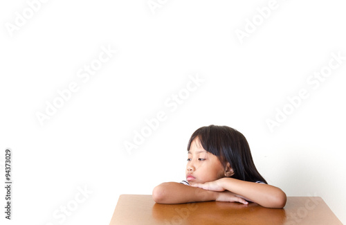 Fotografia, Obraz Bored children girl sitting at the table