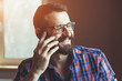 bearded man talking on phone and smiling