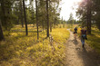 Two young women hiking a trail with golden grass, Wyoming.