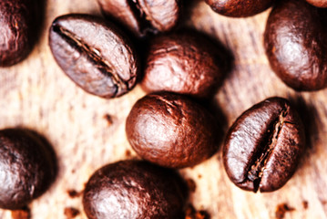 Canvas Print - Coffee beans on macro ground coffee background, top view image.