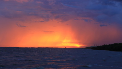 Wall Mural - Storm with sunset in evening light on the beach