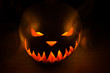 Spooky Halloween Pumpkin with fire in the dark