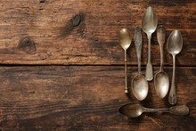 Metal Spoons On Wooden Table