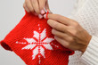 Close up of woman knitting pattern of a snowflake