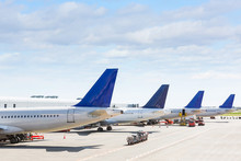 Tails Of Some Airplanes At Airport During Boarding Operation