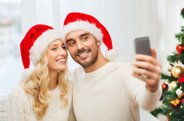 Canvas Print - couple taking selfie with smartphone at christmas