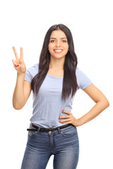 Wall Mural - Young woman making a peace sign