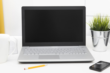 Wall Mural - laptop with blank screen on white table