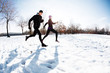 Couple running on snow
