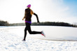 © baranq - Blurred picture of young woman running at winter