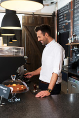 Canvas Print - Happy barista grinding coffee