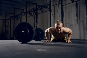 Wall Mural - Happy man training burpees at gym