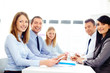 © baranq - Group of happy business people at meeting
