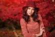 © ZoomTeam - Smiling woman in red autumn park