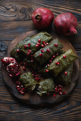 Wall Mural - Dolmades served with pomegranate seeds, top view, studio shot