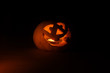 Funny halloween little pumpkin in the dark with light inside
