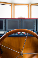 Captain's post with a steering wheel and the central control panel