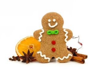 Christmas gingerbread man with cookie cutter and holiday spices isolated on white