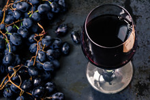 Wineglass Of Red Wine With Grapes