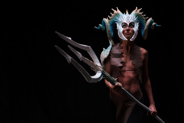 Fantasy concept of a young girl,strong brave warrior,wearing a helmet - mask with horns on head with corals with dots