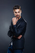 © djile - Portrait of handsome man in a studio on a dark background