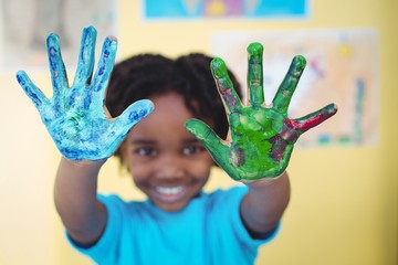 Wall Mural - Smiling kid holding up his hands