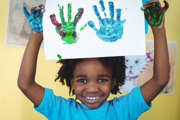 Smiling kid holding up his hands