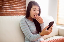 Asian Woman Reading Shocking Text