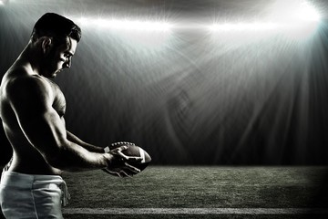 Canvas Print - Composite image of shirtless american football player with ball