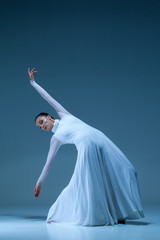 Wall Mural - Portrait of the ballerina on blue background