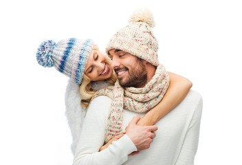 Canvas Print - smiling couple in winter clothes hugging