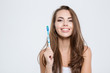 © Drobot Dean - Cute woman holding toothbrush