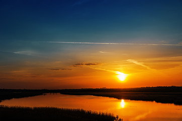 Wall Mural - dark orange sunset over river