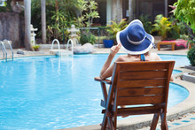 Summer Holidays, Woman Relaxing In Beautiful Luxury Hotel Near Swimming Pool