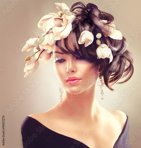 Naklejka na kafelki Beauty woman portrait. Fashion brunette girl with magnolia flowers hairstyle