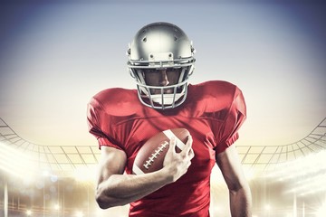 Canvas Print - Composite image of american football player holding ball